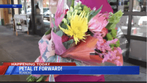 Woman holding colorful flowers during Petal it Forward
