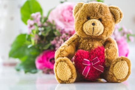 Bouquet of flowers with brown teddy bear and big pink heart